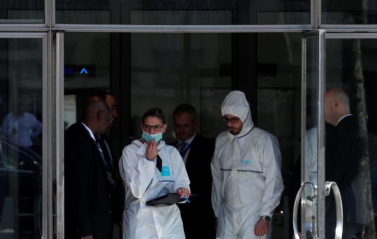 Members of the scientific Police leave the International Monetary Fund (IMF) offices where an envelope exploded in Paris