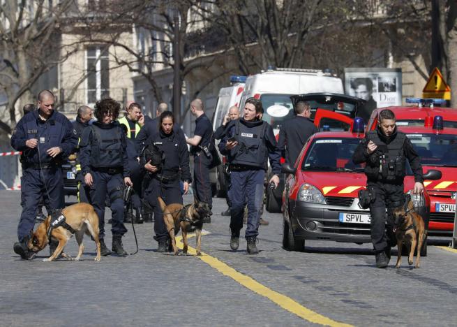 Police outside the International Monetary Fund offices where an envelope exploded in Paris