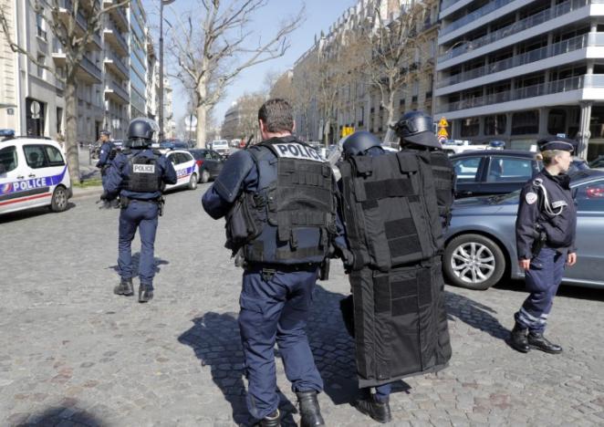 Police outside the International Monetary Fund offices where an envelope exploded in Paris