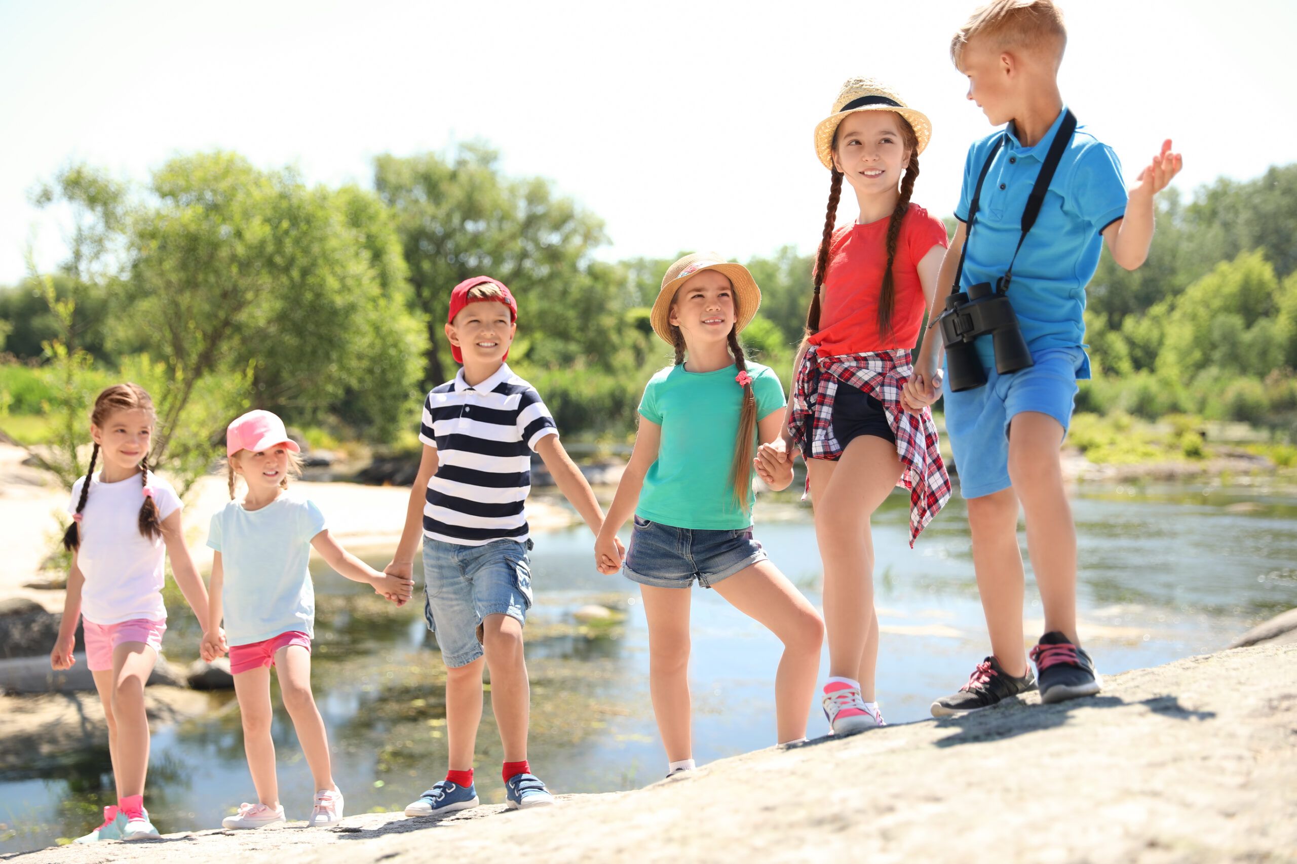 Little children with binoculars outdoors. Summer camp