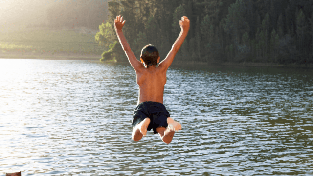 хлопчик стрибає в озеро, хлопчик біля річки, літо